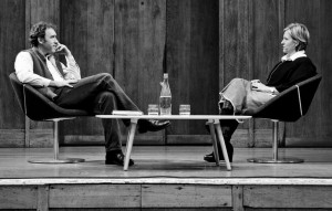 Roman Krznaric and Brene Brown sitting facing each other on stage at the Conway Hall, London on 3 October 2012